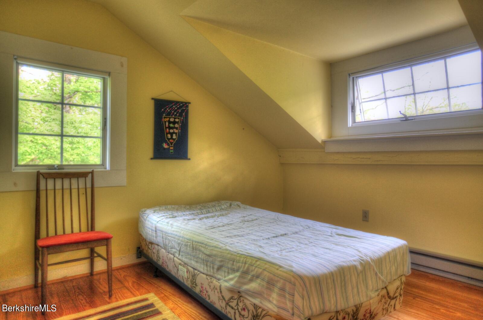 5 South Beech Plain Road Sandisfield, MA 01255 - Photo 26 of 36 a bedroom with a bed and wooden floor