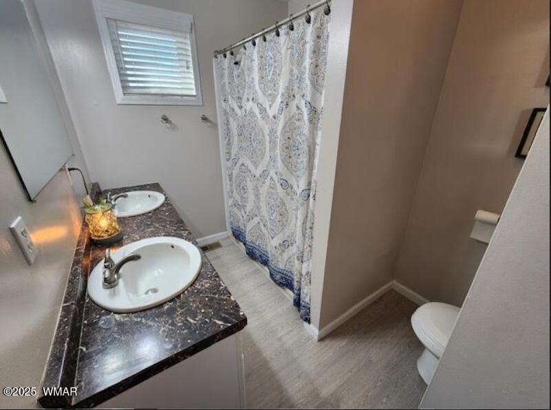 121 Harmony Lane Springerville, AZ 85938 - Photo 9 of 28 a bathroom with a granite countertop sink toilet and shower