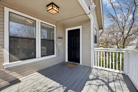 a view of a balcony with wooden floor