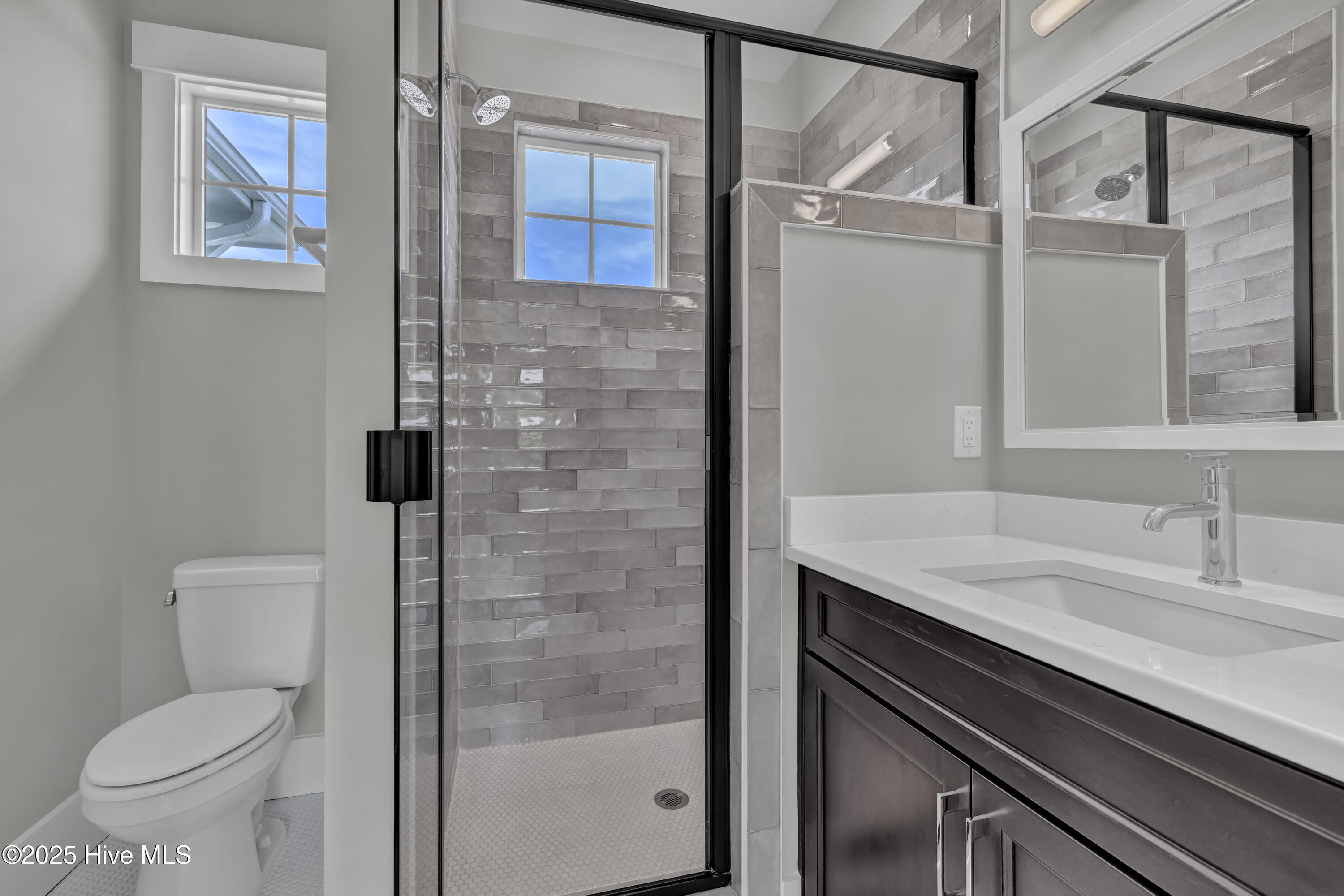 357 Planters Walk Hampstead, NC 28443 - Photo 46 of 62 Upstairs shower glistens with this splendid tile selection.