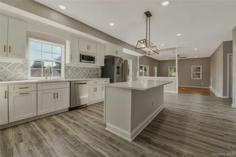 a view of a house with a yard and sitting area