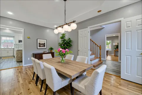 a large kitchen with stainless steel appliances granite countertop a large center island attached withe living room