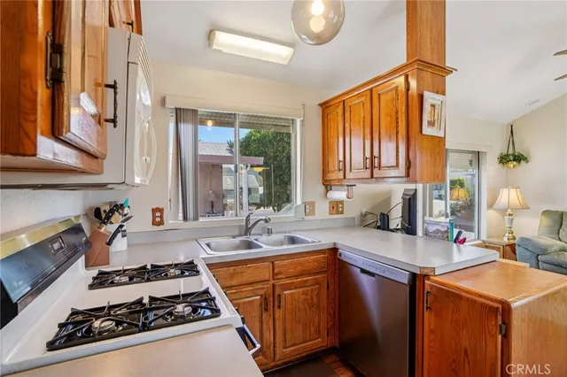 a kitchen with stainless steel appliances granite countertop a stove and a sink