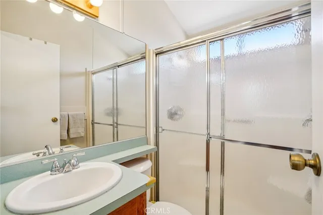 a bathroom with a shower and a sink