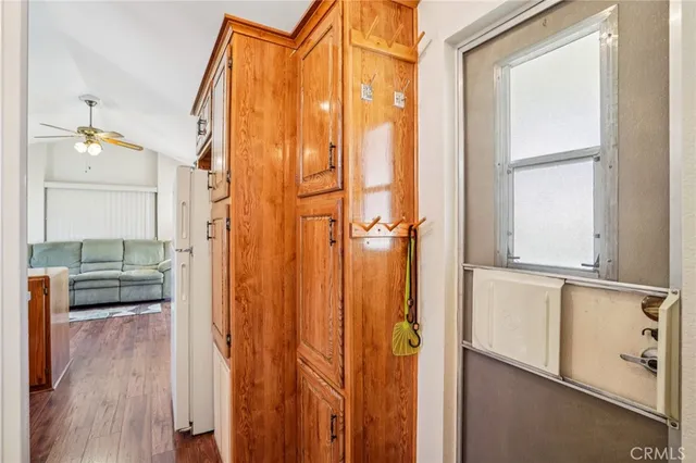 a bedroom with a bed a dresser and potted plant