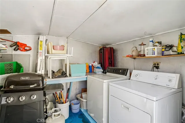 a view of a patio with table and chairs with wooden fence and plants