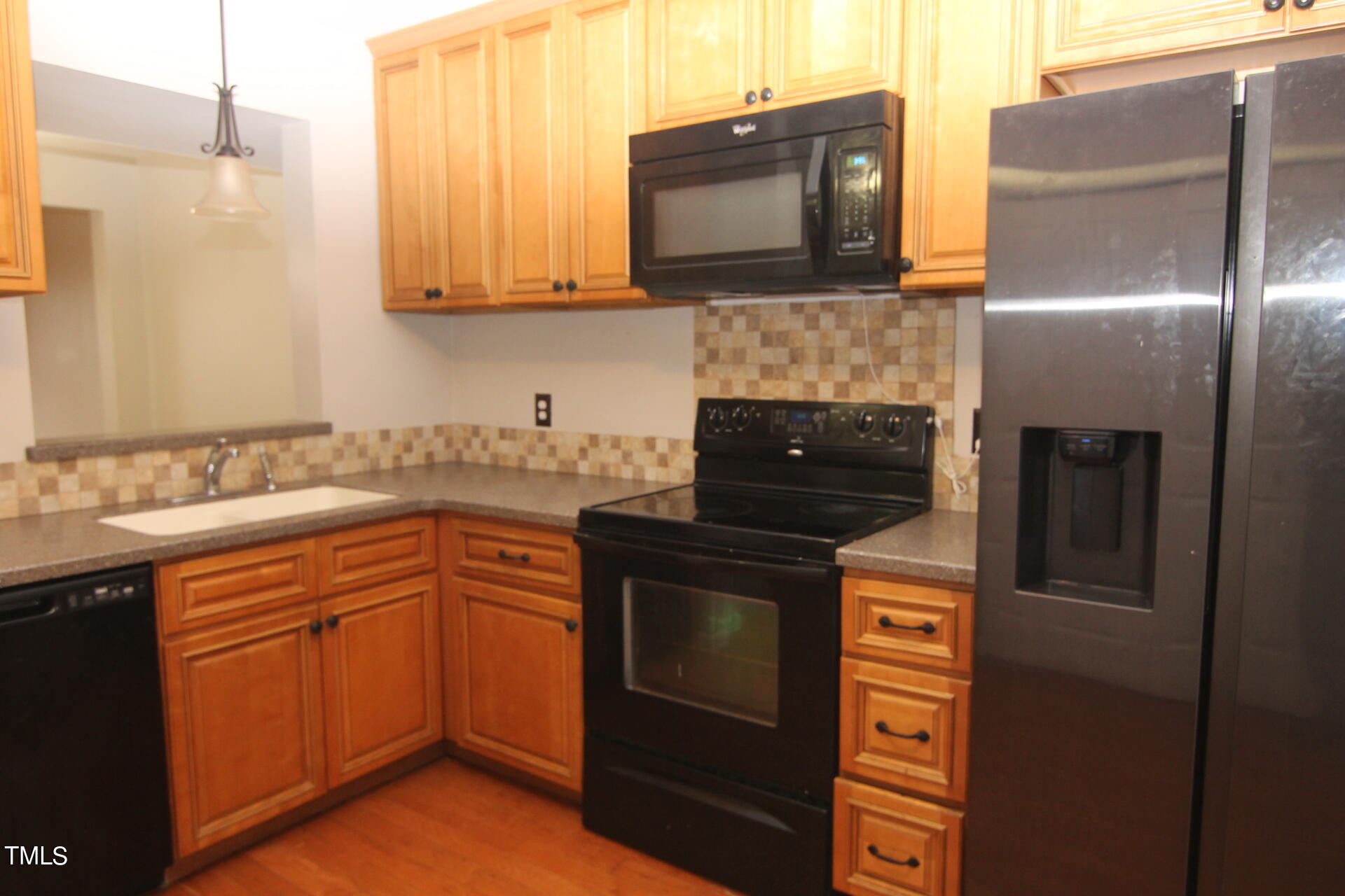 4516 Still Pines Drive Raleigh, NC 27613 - Photo 4 of 15 a kitchen with stainless steel appliances granite countertop a stove top oven microwave and refrigerator