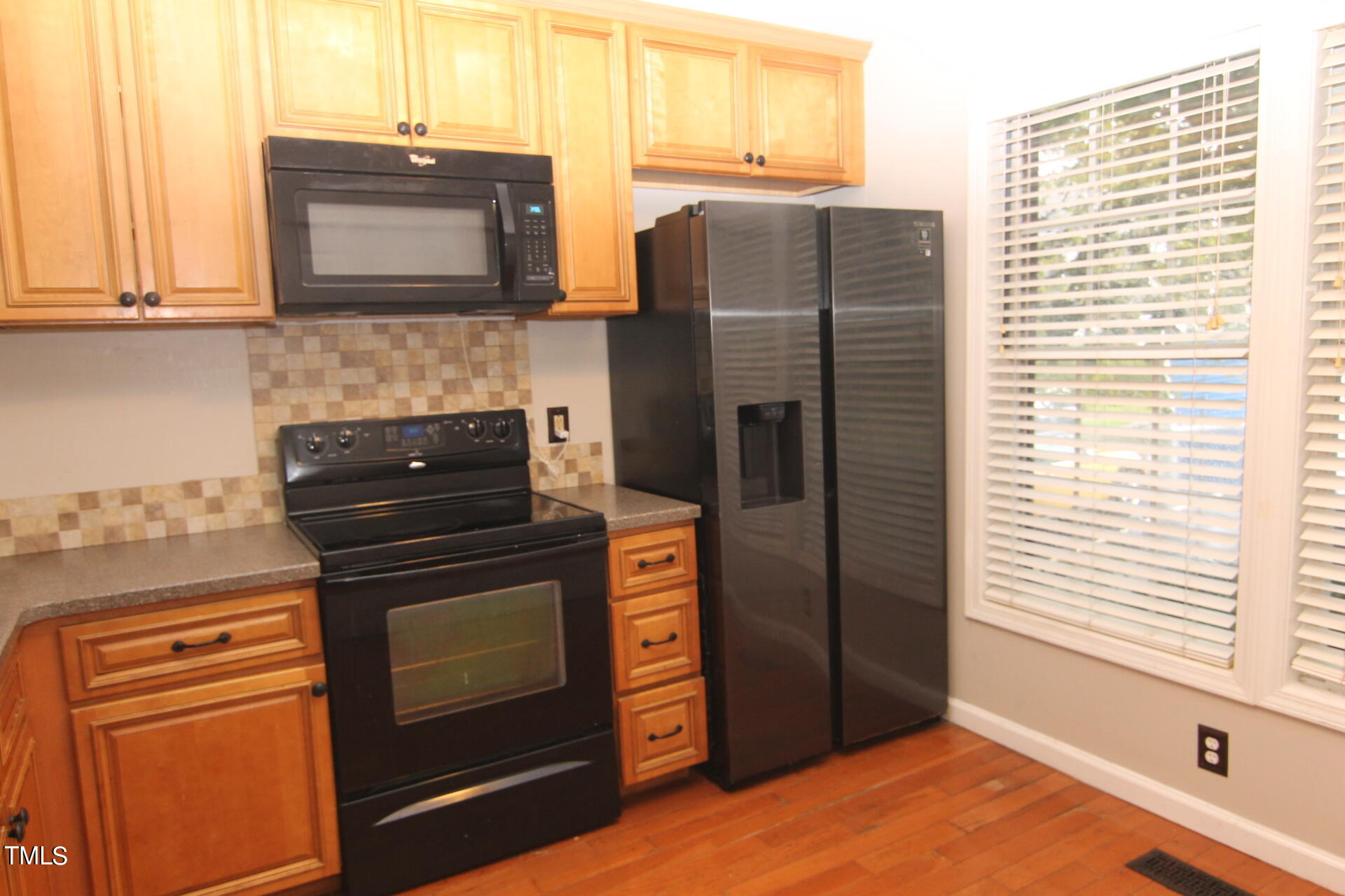 4516 Still Pines Drive Raleigh, NC 27613 - Photo 5 of 15 a kitchen with stainless steel appliances granite countertop a refrigerator and a stove top oven