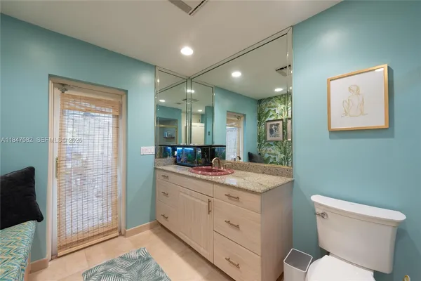 a bathroom with a toilet sink and mirror