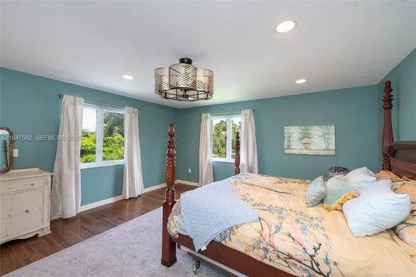 a bedroom with a large bed and a window