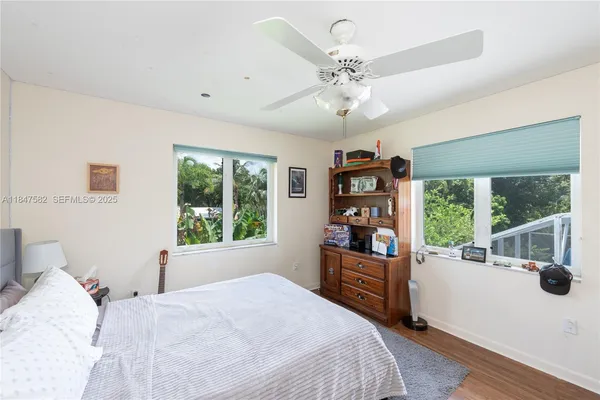 a bedroom with a large bed and a large window