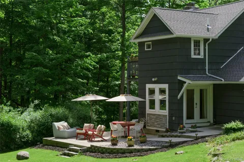 a front view of a house with a yard table and chairs
