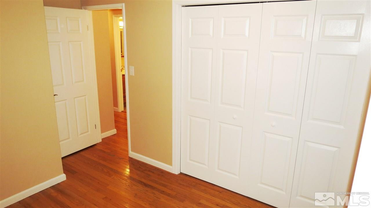 6525 Lotus Street Reno, NV 89506 - Photo 23 of 25 a view of a hallway with wooden floor
