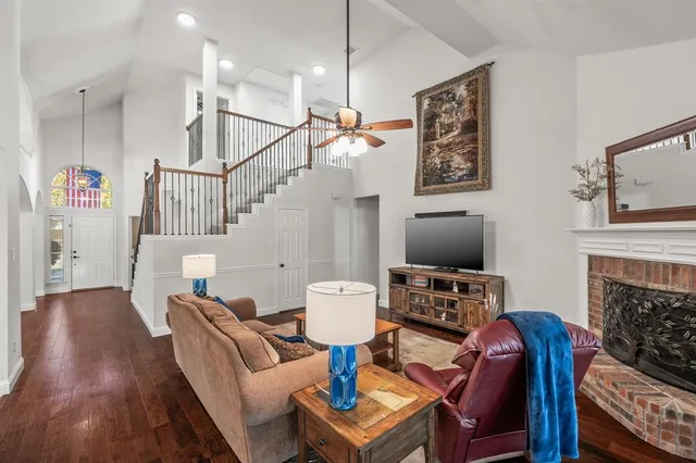 a living room with furniture a fireplace and a flat screen tv