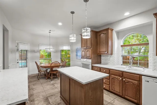 a kitchen with a large window cabinets and stainless steel appliances