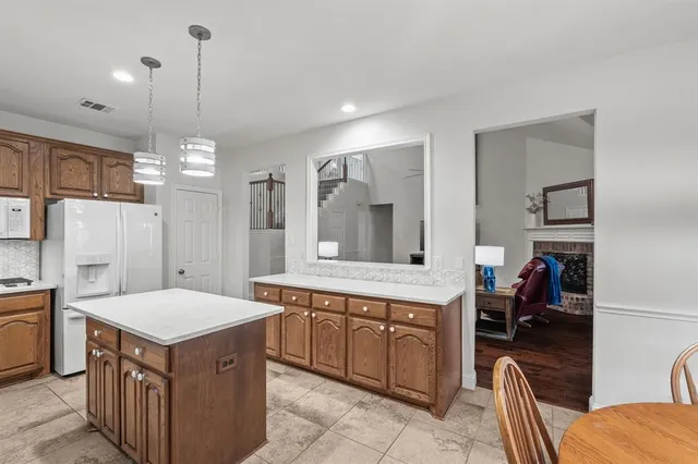 a kitchen that has a lot of cabinets in it and stainless steel appliances