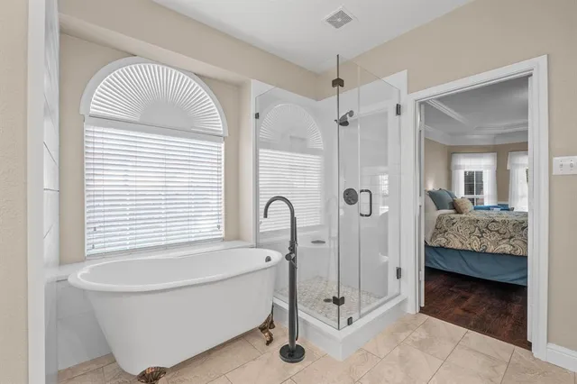a bathroom with a tub and a view of bathroom