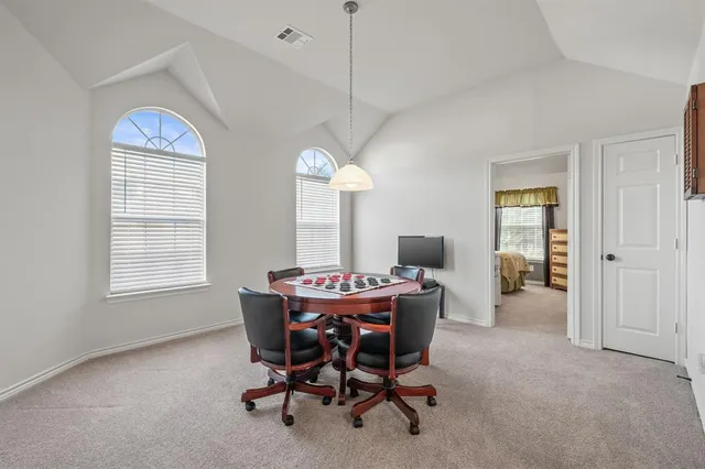 a view of a dining room with furniture and chandelier