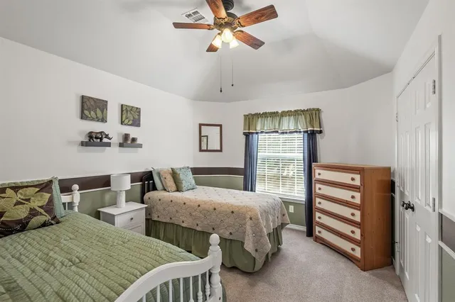 a bedroom with two beds and a chandelier
