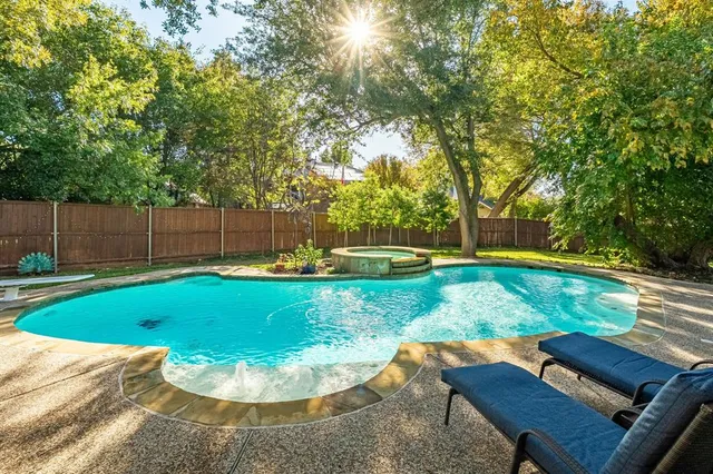 a view of a backyard with plants and a patio