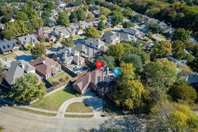 an aerial view of residential house with outdoor space and swimming pool