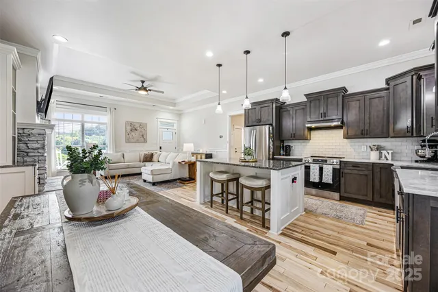 a large white kitchen with lots of counter space a sink and appliances