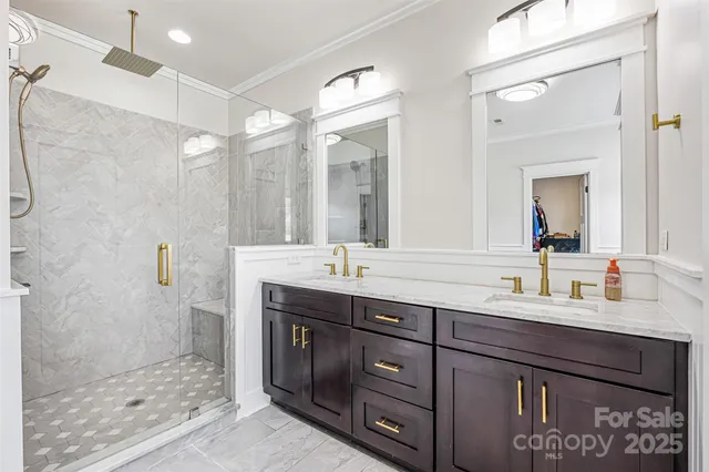 a bathroom with a double vanity sink mirror and shower