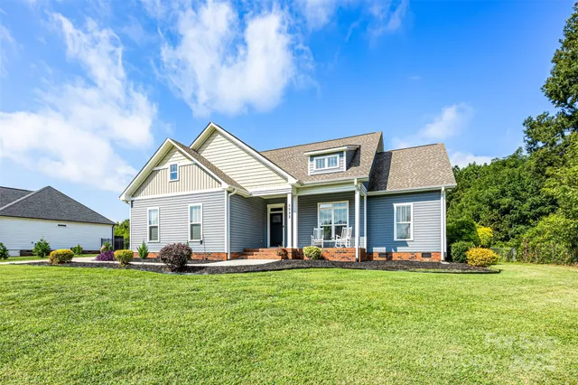 a front view of house with yard and green space