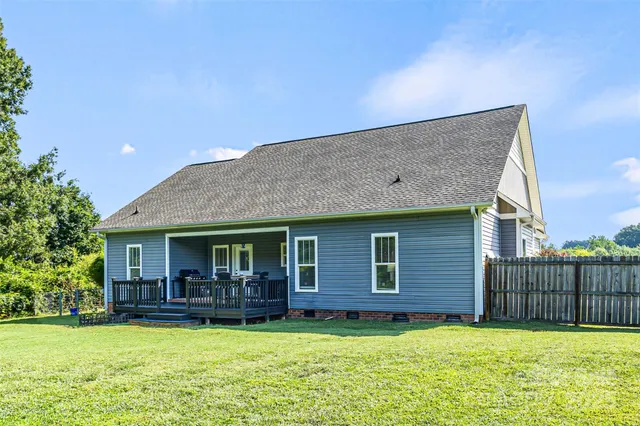 a backyard of a house with yard and glass window