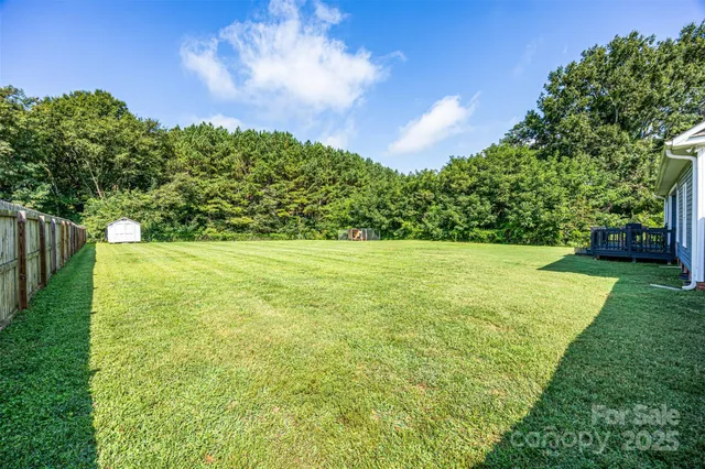 a view of a garden with a building in the background