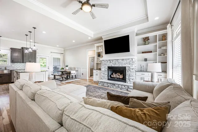 a living room with furniture fireplace and flat screen tv