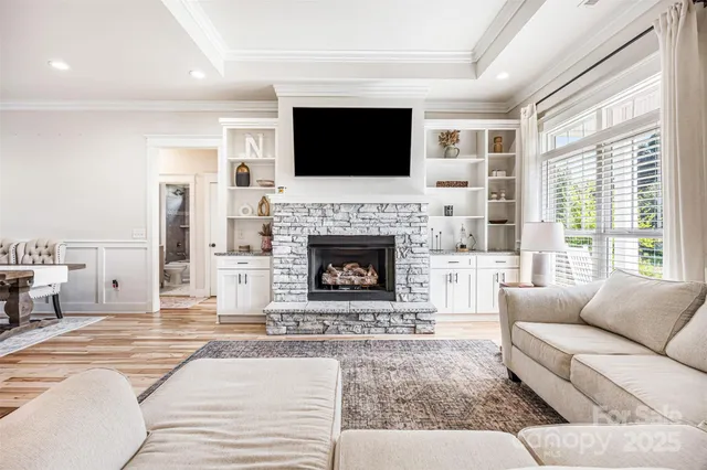 a living room with furniture a flat screen tv and a fireplace