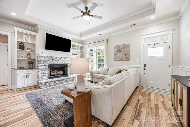 a living room with furniture fireplace and flat screen tv