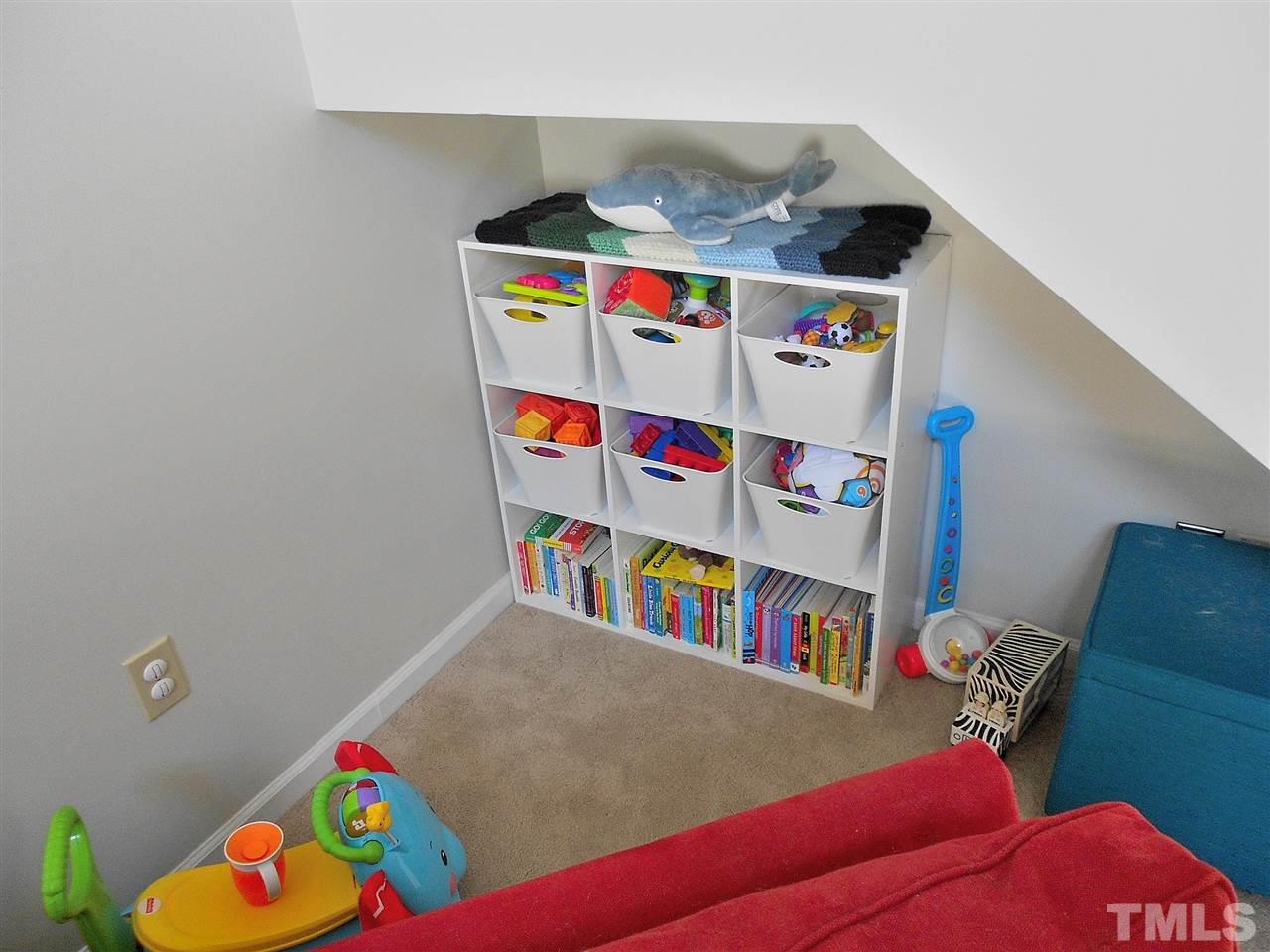 3823 Carnegie Lane Raleigh, NC 27612 - Photo 23 of 25 a living room with baby toys