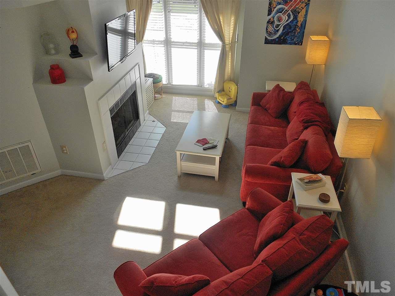 3823 Carnegie Lane Raleigh, NC 27612 - Photo 4 of 25 a living room with furniture and a fireplace
