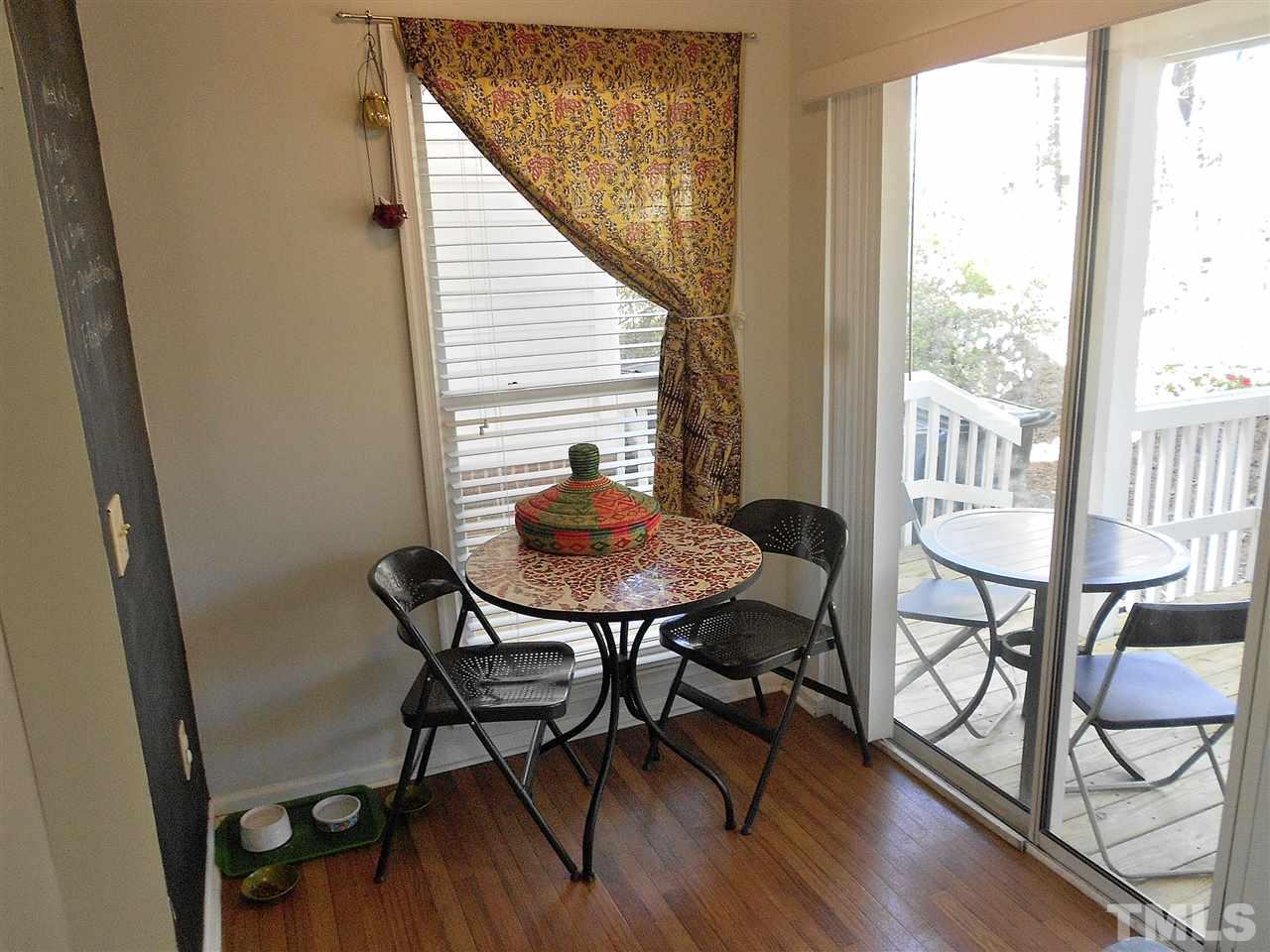 3823 Carnegie Lane Raleigh, NC 27612 - Photo 8 of 25 a view of a dining room with furniture and wooden floor