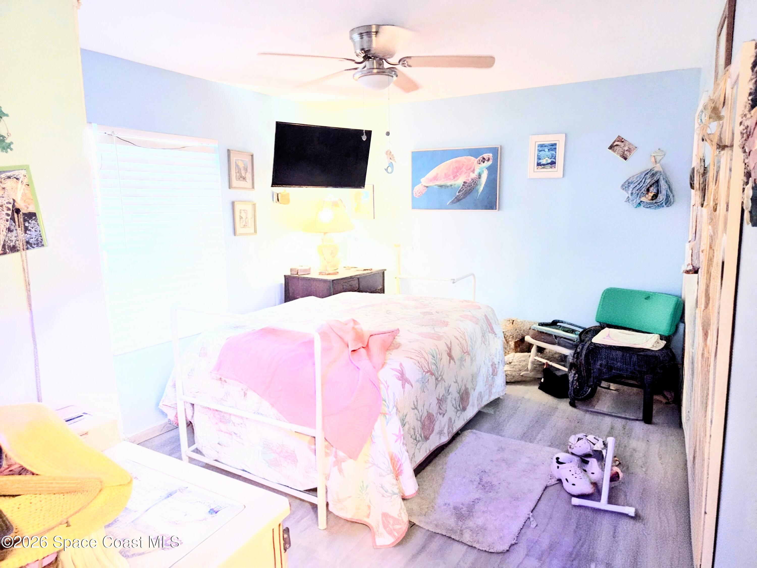 416 North 4th Street Cocoa Beach, FL 32931 - Photo 11 of 22 a bedroom with a bed and a flat screen tv