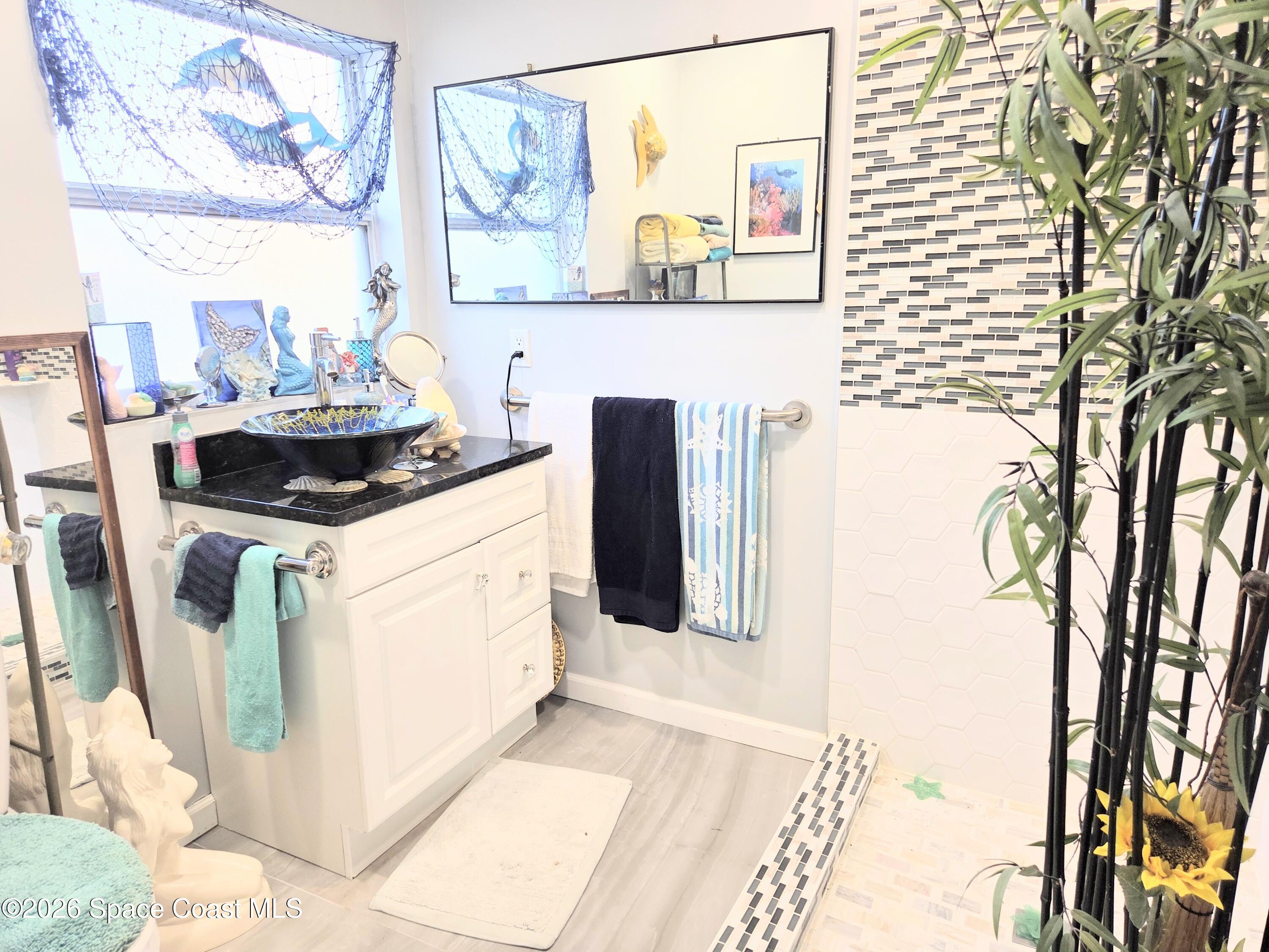 416 North 4th Street Cocoa Beach, FL 32931 - Photo 12 of 22 a kitchen with stainless steel appliances a stove a microwave and a potted plant