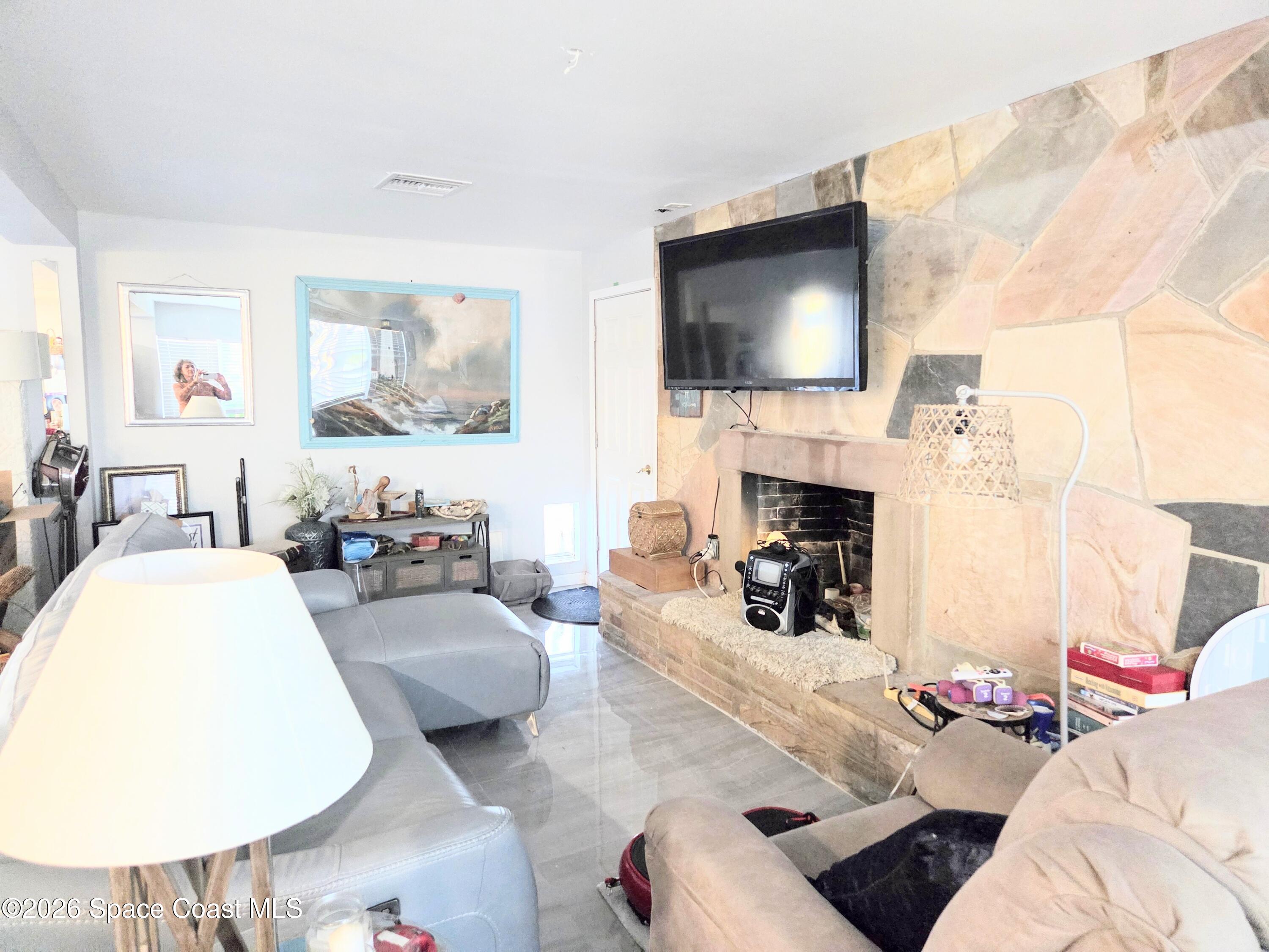 416 North 4th Street Cocoa Beach, FL 32931 - Photo 8 of 22 a living room with furniture and a flat screen tv