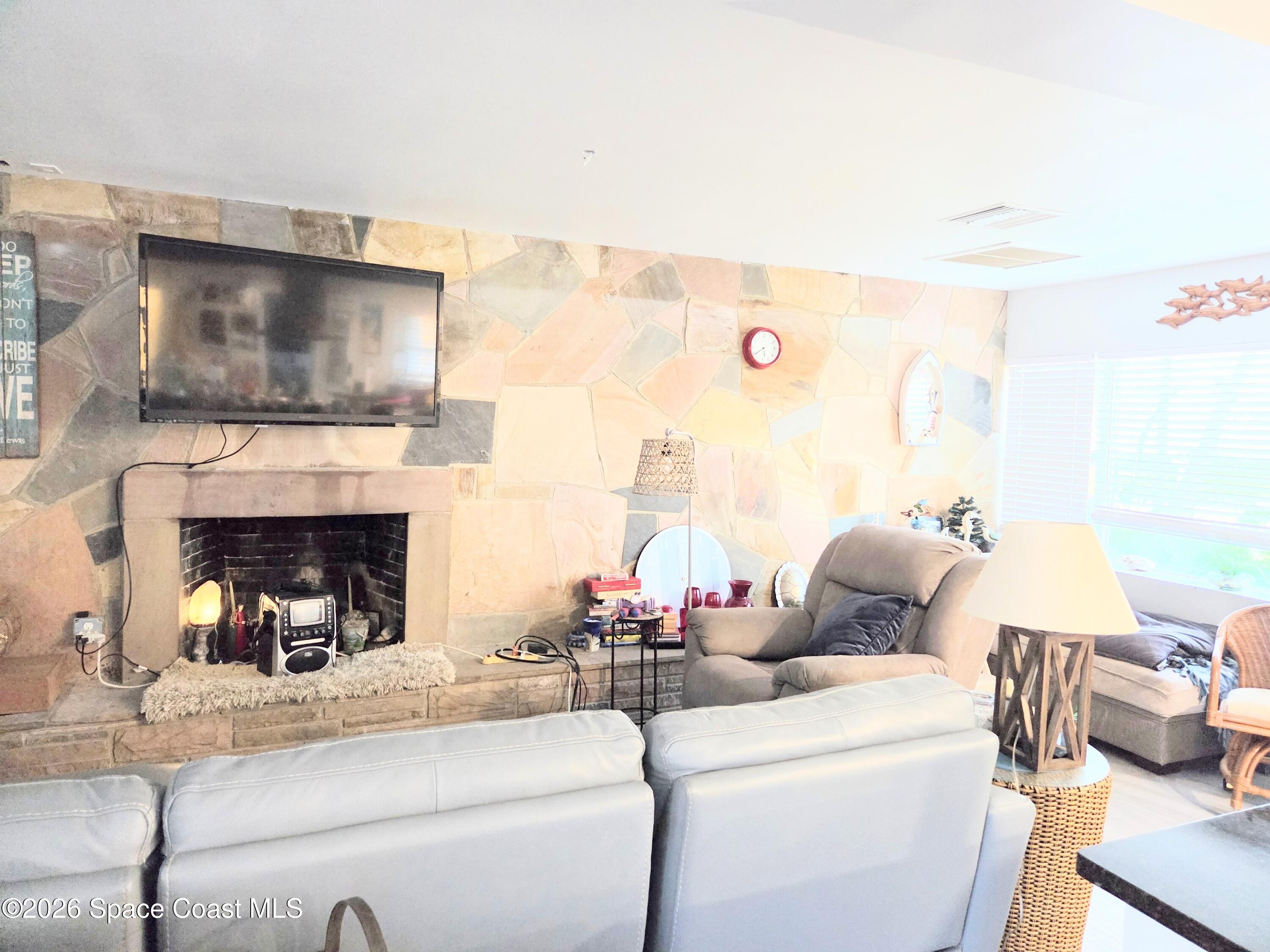 416 North 4th Street Cocoa Beach, FL 32931 - Photo 9 of 22 a living room with furniture and a fireplace