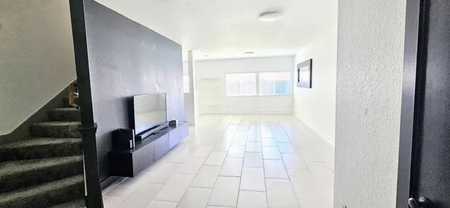 a view of a hallway with a flat screen tv