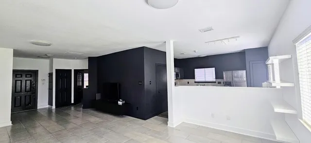 a kitchen with stainless steel appliances kitchen island wooden cabinets and refrigerator