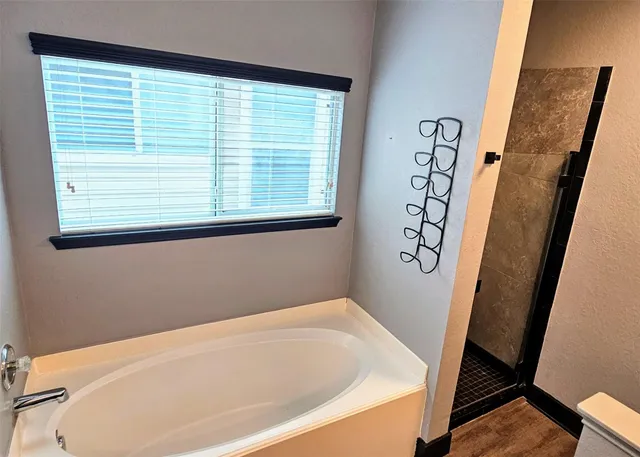 a bathroom with a bathtub and a window