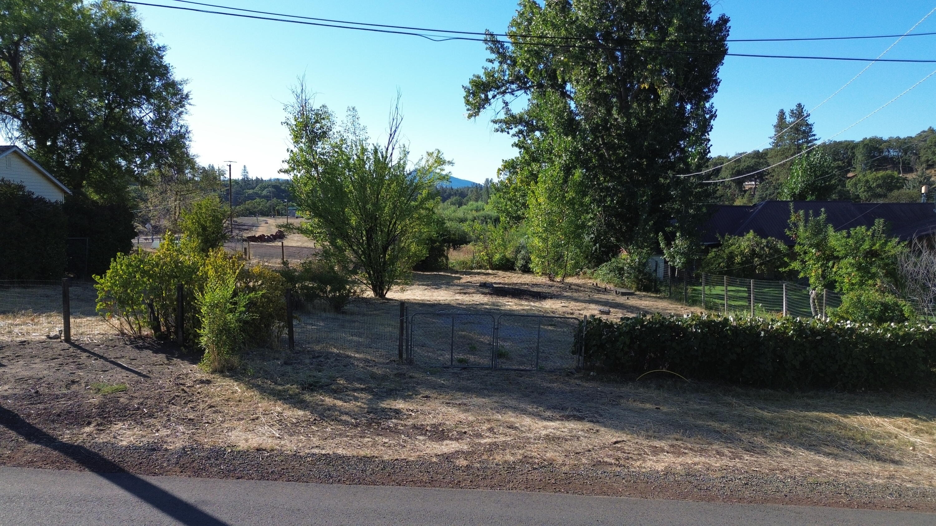 43195 Bridge Street Fall River Mills, CA 96028 - Photo 1 of 20 a backyard of a house with lots of green space
