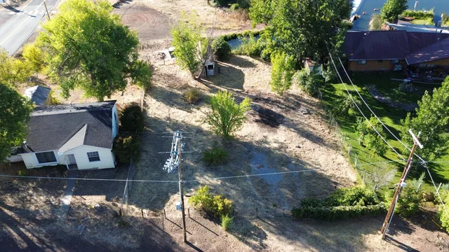 an aerial view of a house with a yard
