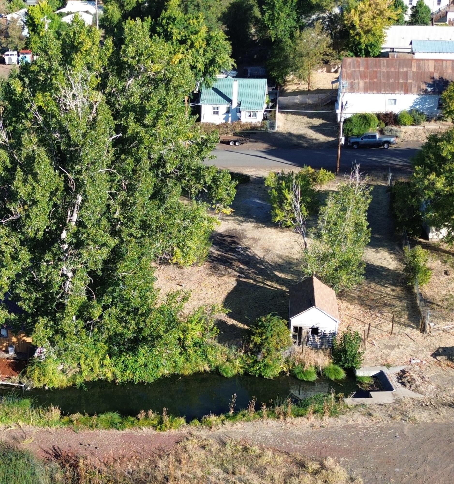 43195 Bridge Street Fall River Mills, CA 96028 - Photo 3 of 20 an aerial view of a house with a yard and lake view