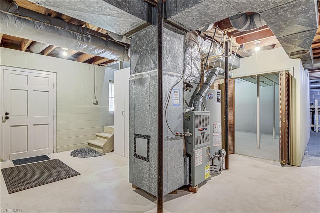 2606 Maxine Drive High Point, NC 27265 - Photo 25 of 34 Unfinished basement. Stairs lead to main, door on the left leads to backyard. Bifold doors lead to downstairs den.
