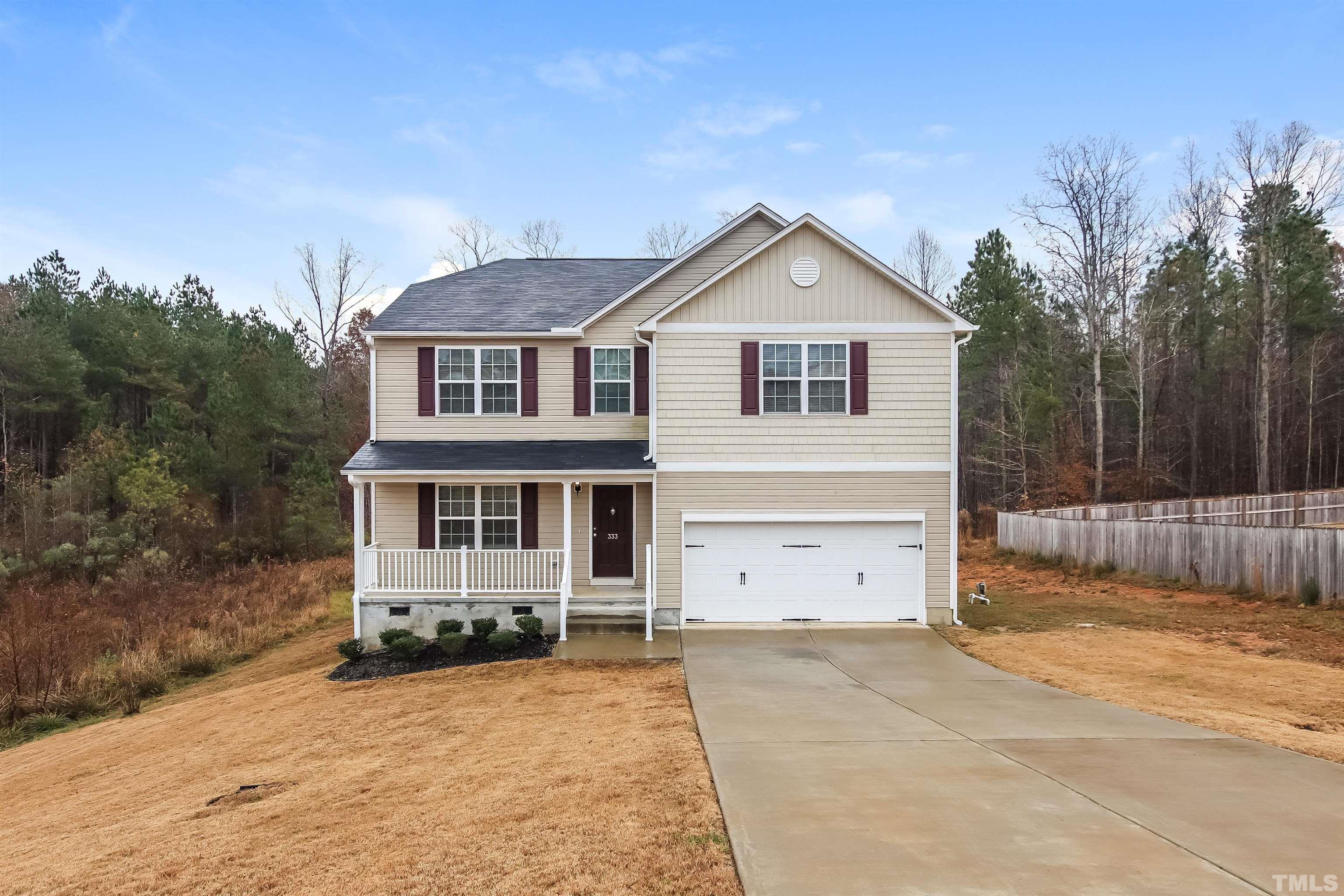 333 Sequoia Drive Clayton, NC 27527 - Photo 1 of 17 a front view of a house with a yard and garage