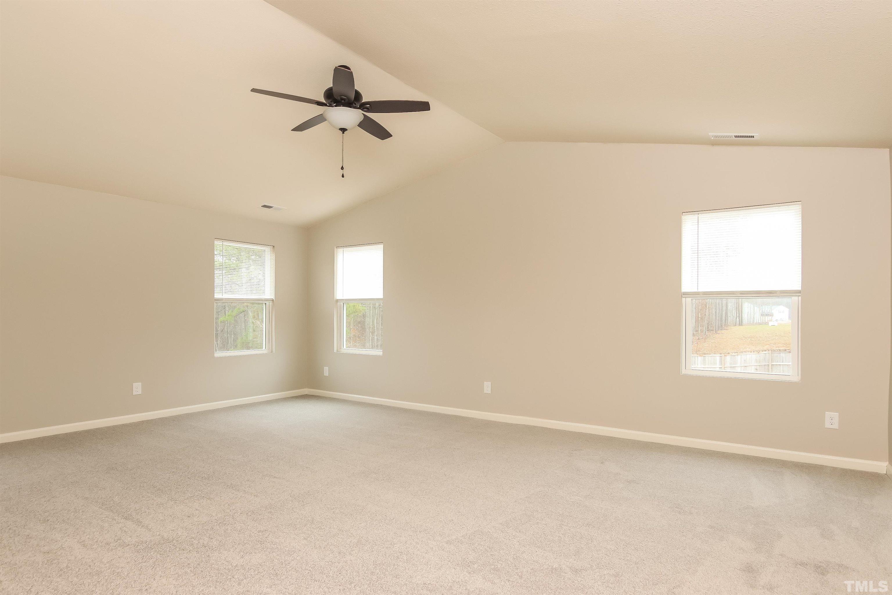 333 Sequoia Drive Clayton, NC 27527 - Photo 11 of 17 an empty room with a window and a ceiling fan