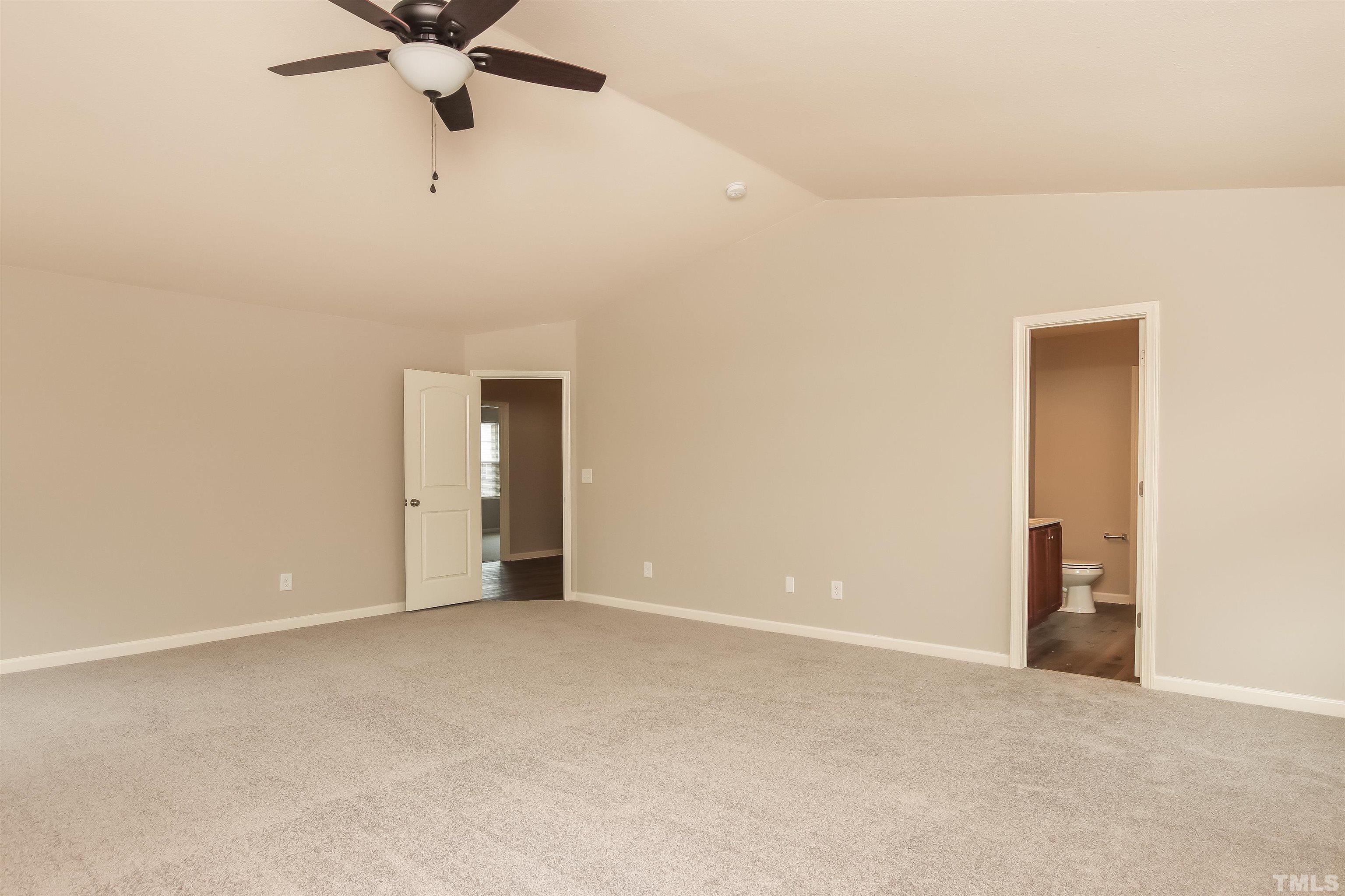 333 Sequoia Drive Clayton, NC 27527 - Photo 12 of 17 an empty room with a ceiling fan and carpet